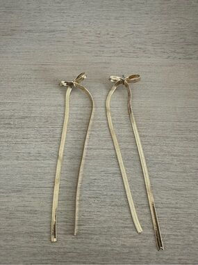 Long dangle gold bow earrings
